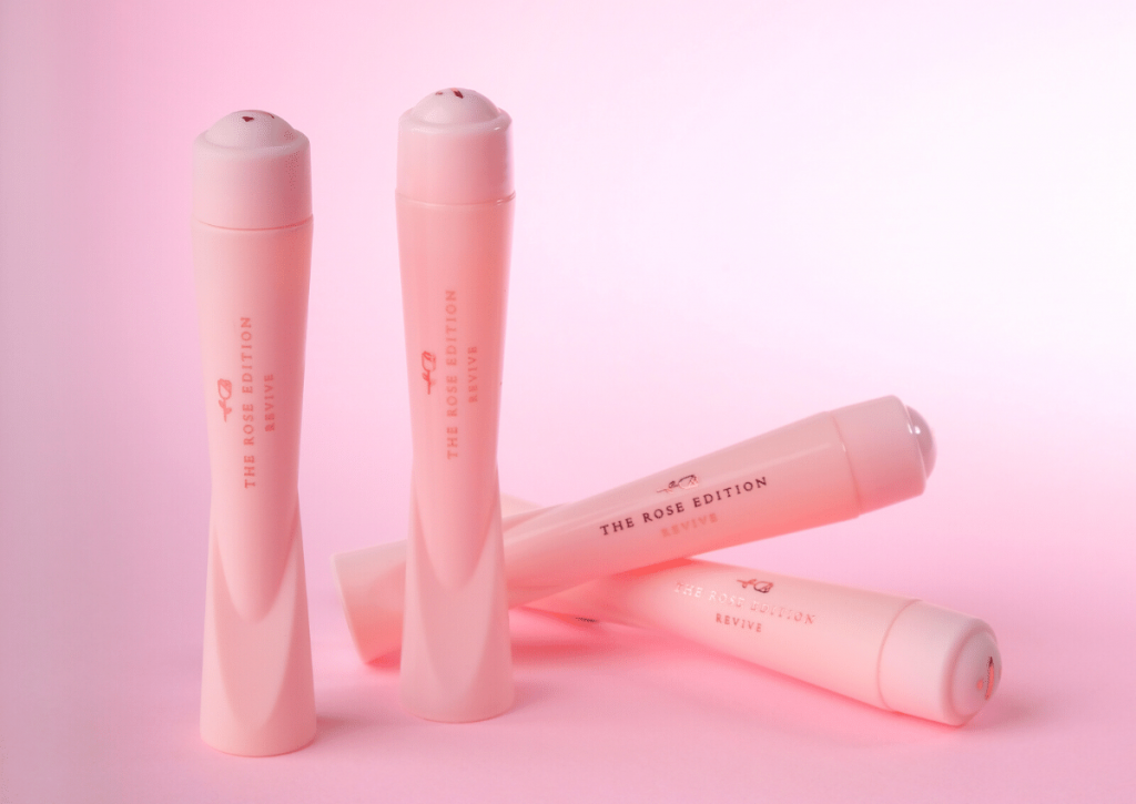 dr nima london revive lip plumpers four bottles of the revive product against a pink background